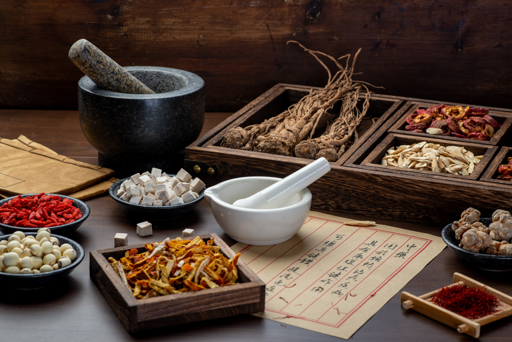 Ancient,Chinese,Medicine,Books,And,Herbs,On,The,Table